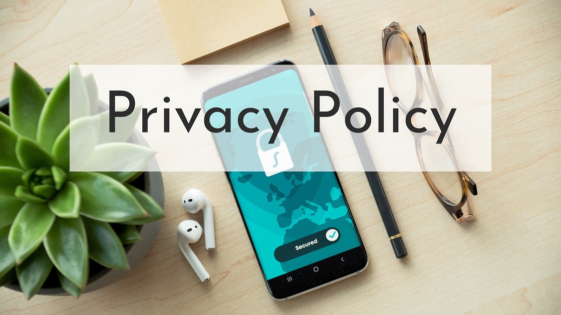 Privacy Policy banner with plant, phone, pencil and glasses on a book editor's desk.
